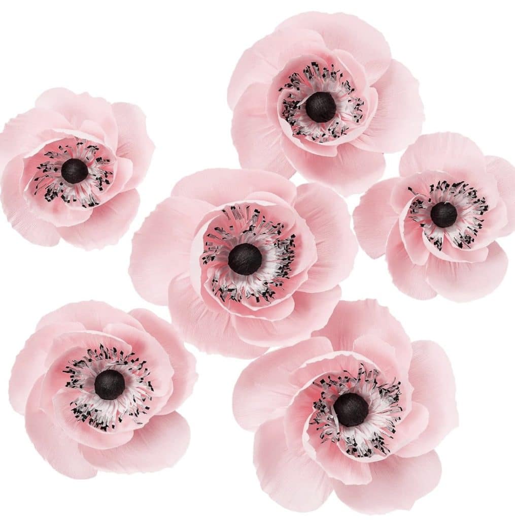 Six delicate pink anemone flowers with black centers and white petals tinged with light pink, perfect for a DIY garland, arranged against a plain white background.